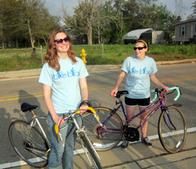 Two cyclists smile at the camera